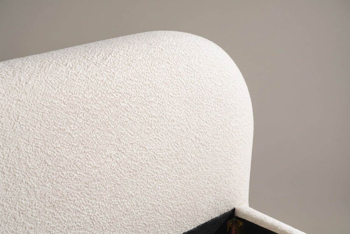 Close-up of the rounded corner of the Pollutri headboard in cream white boucle