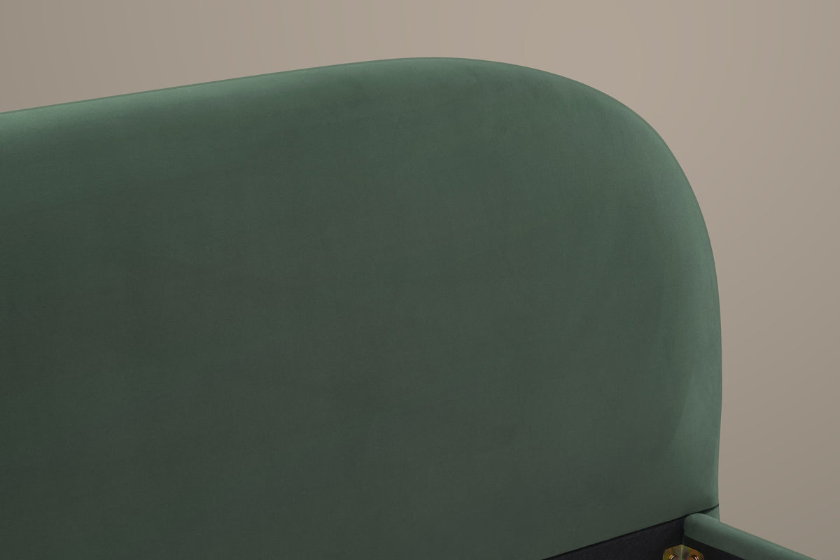Close-up of the rounded corner of the Pollutri headboard in dark green velvet