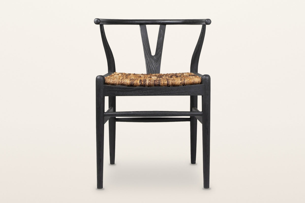 Poppi Y-back dining chair in Black, front view on a warm white studio backdrop: a black teak frame with a natural abaca seat