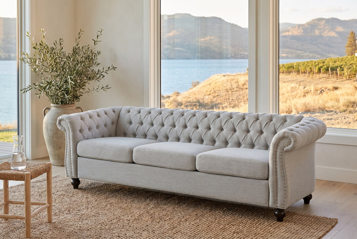 Portovenere sofa in a Kelowna lake house with a jute rug, olive branches and the lake and vineyards beyond the windows