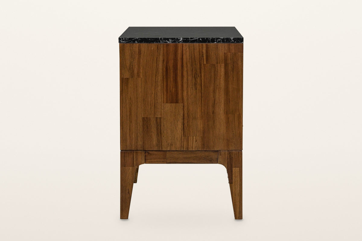 Side view of the Postignano nightstand in Walnut on a warm white studio backdrop: a side of short acacia blocks under the bla