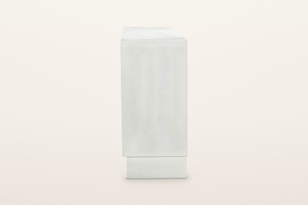 The right end of the Pragelato sideboard: a plain flat end panel over the plinth, set back under the case