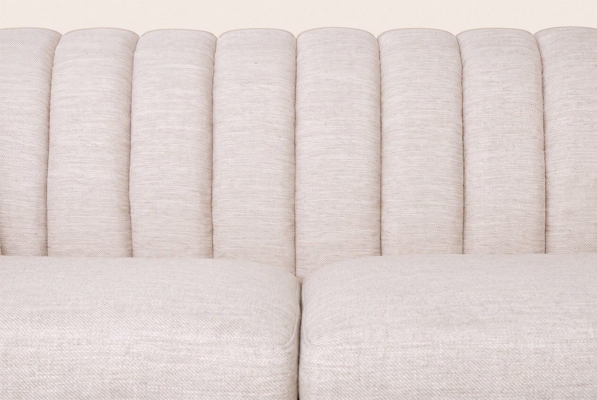 Close-up of the channel-stitched back and the two beige seat cushions