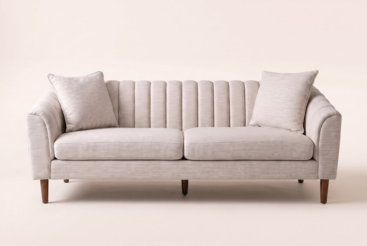 Prato sofa in beige, straight front view: a channel-stitched back, sloped arms, two seat cushions and two pillows