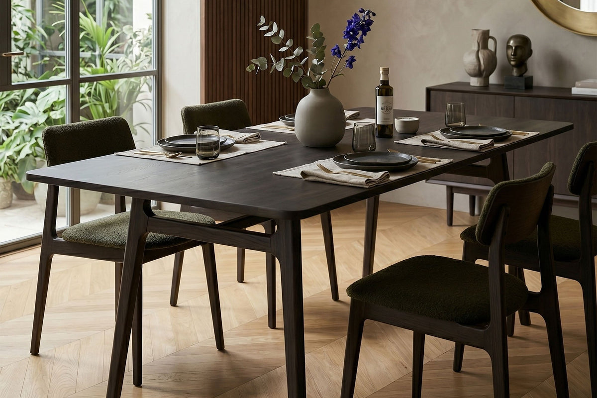 Prescott antique black dining table set for dinner in a bright dining room