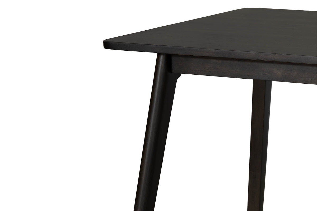 Close-up of the Prescott table in Antique Black: the rounded corner, the apron and a round tapered leg with its curved notch