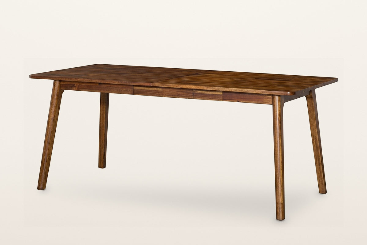 Prescott round-leg extension dining table in Brown, closed to 70 in, three-quarter view on a warm white studio backdrop: a long acacia top with rounded corners on four round tapered splayed legs