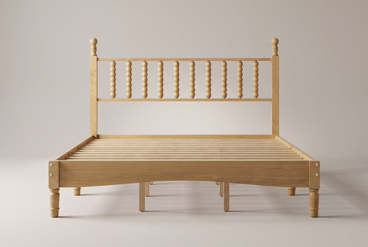 Ravenna spindle bed in Natural, straight front view on a studio backdrop