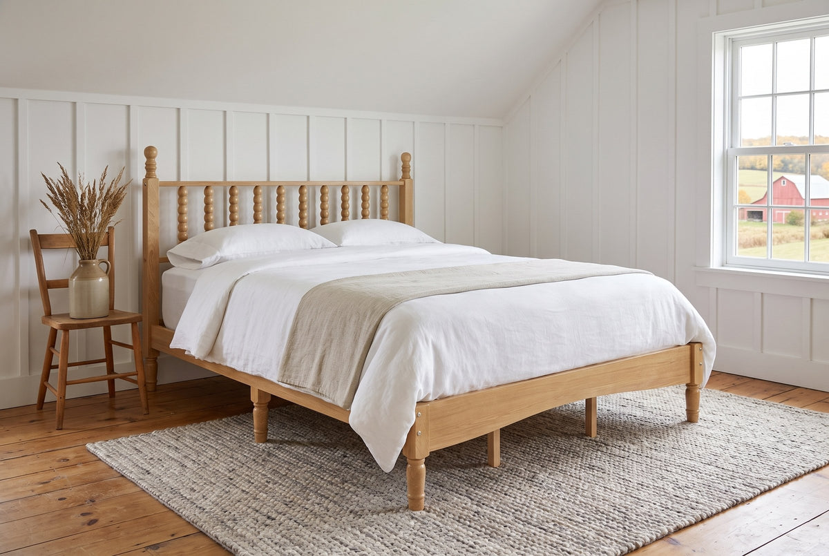 Ravenna spindle bed in a white board-and-batten farmhouse bedroom with a view of fields and a red barn