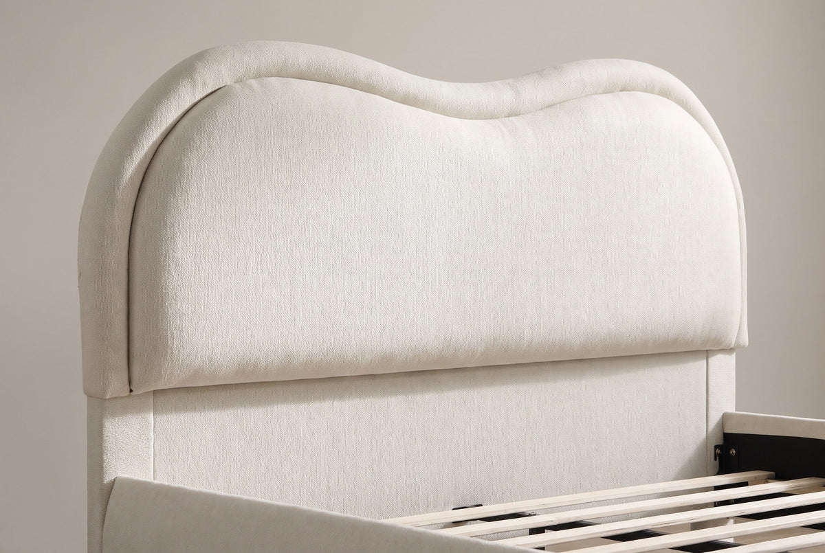 Close-up of the Recanati headboard: the wavy top, the thick rolled chenille border and the padded panel over the lower panel