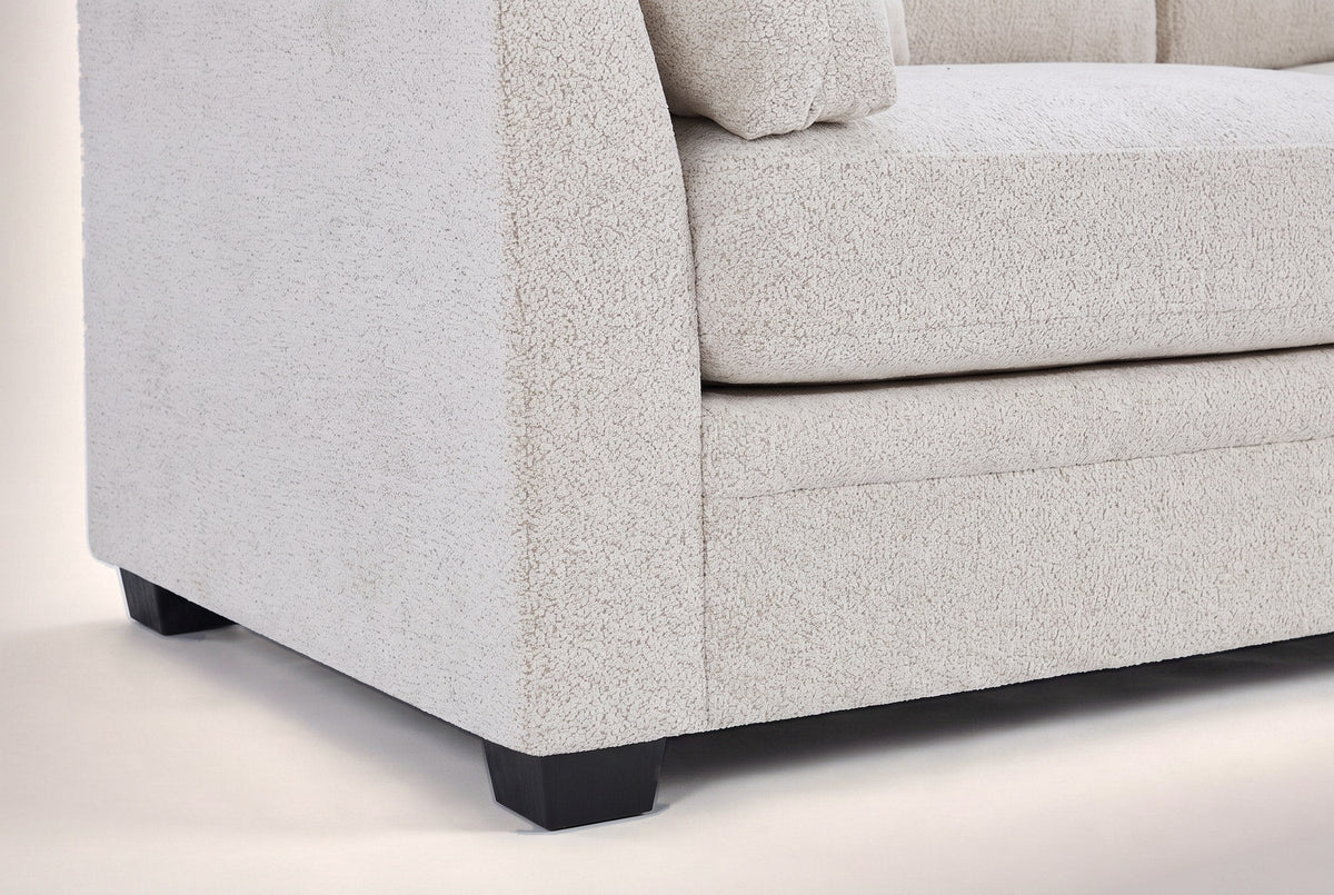 Close-up of the arm front, the base seam and two black tapered legs