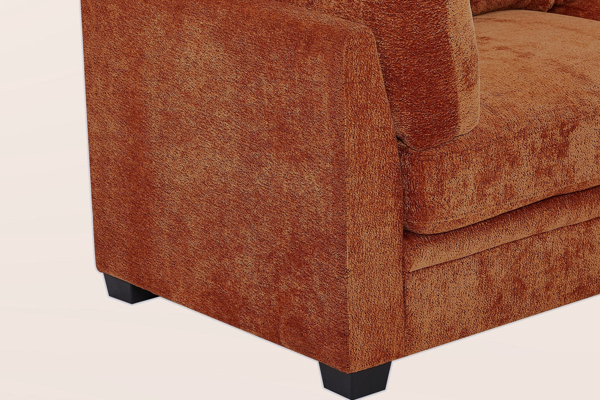 Close-up of the caramel chenille arm, the base seam and two black tapered legs