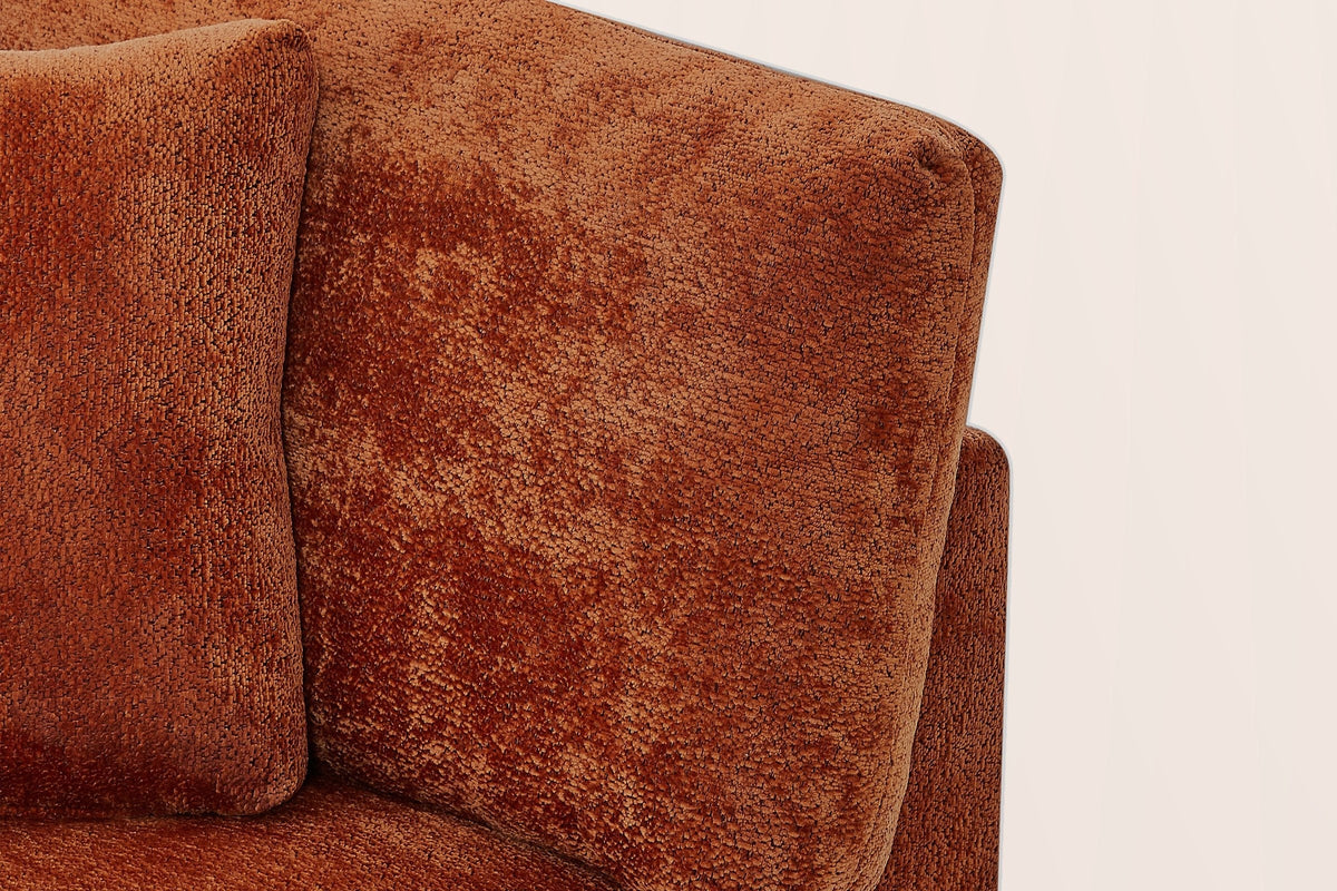 Close-up of the caramel chenille arm pillow, a square pillow, the seat cushion and the square top of the flared arm