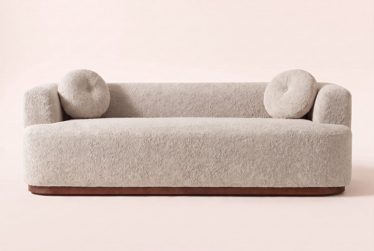 Sabbioneta sofa in Almond boucle, straight front view: one long bench seat, a tight back, block arms and two round pillows