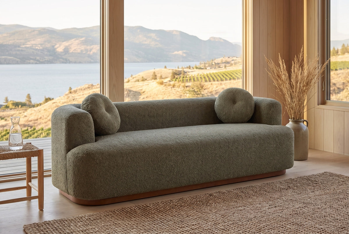 Sabbioneta sofa in a Kelowna lake house with a jute rug, a rush stool and Okanagan Lake through the windows