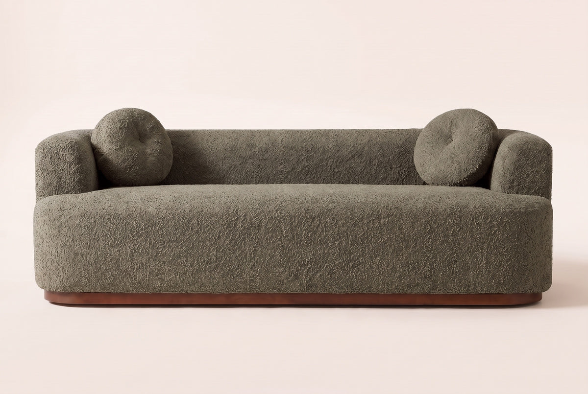 Sabbioneta sofa in olive green boucle, straight front view: one long bench seat, a tight back, block arms and two round pillows