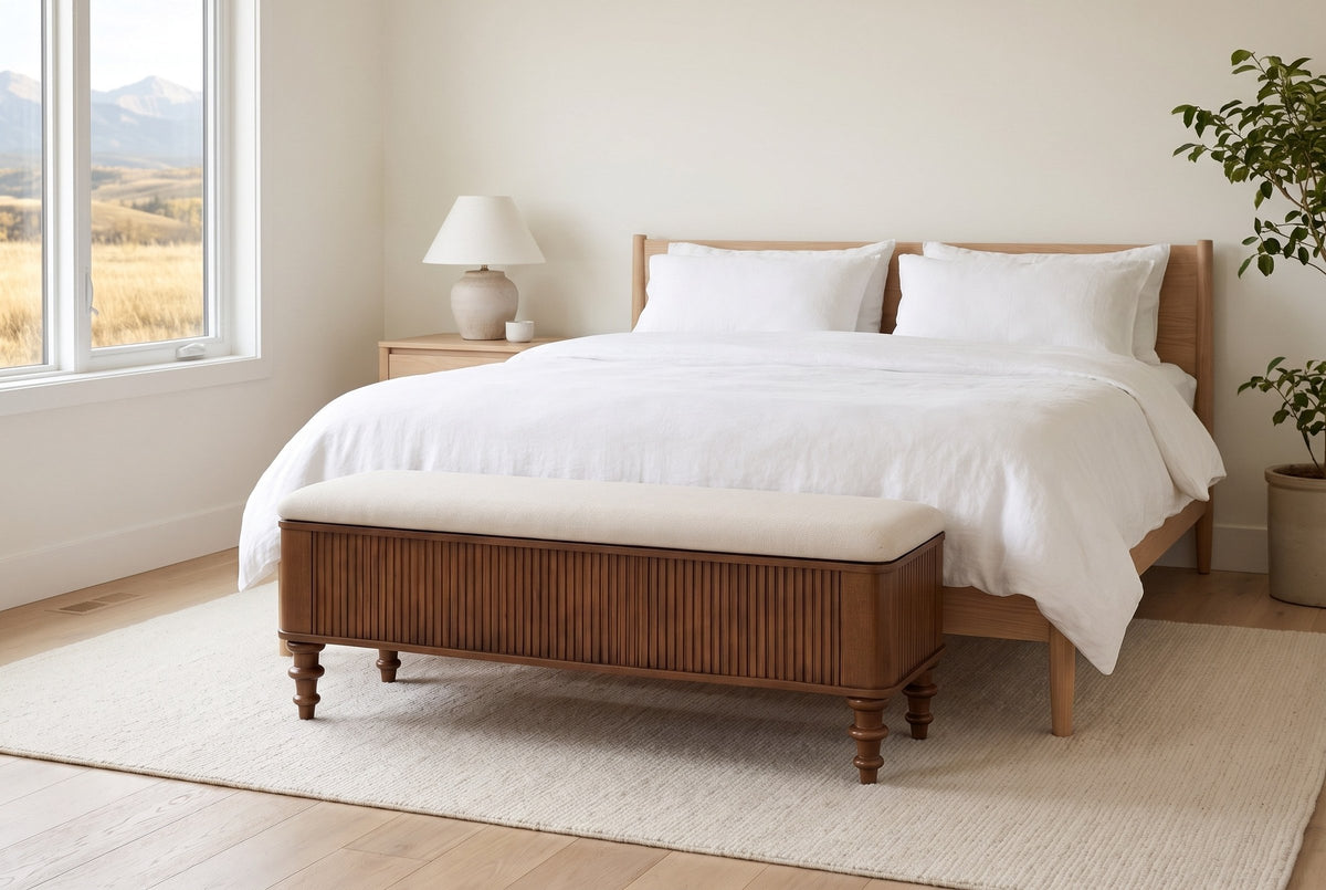 Salerno storage bench at the foot of a bed with white linen in a Calgary bedroom, golden foothills in the window