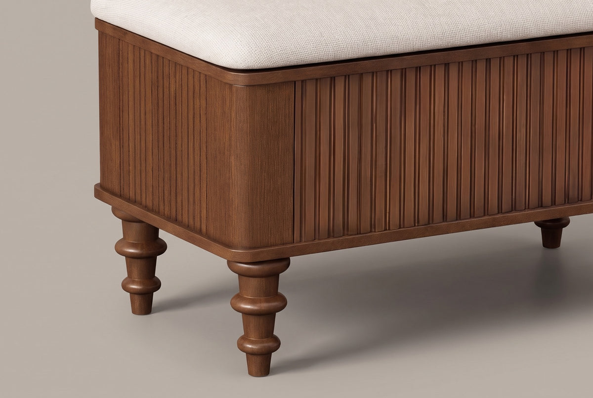 Close-up of a rounded corner of the Salerno bench: reeded end and front, the plinth and two turned walnut legs