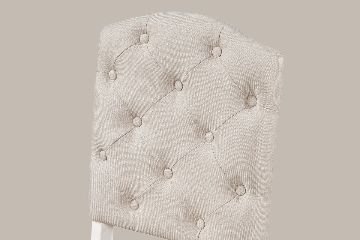 Close-up of the Saluzzo chair back: diamond tufting with fabric-covered buttons and the arched top