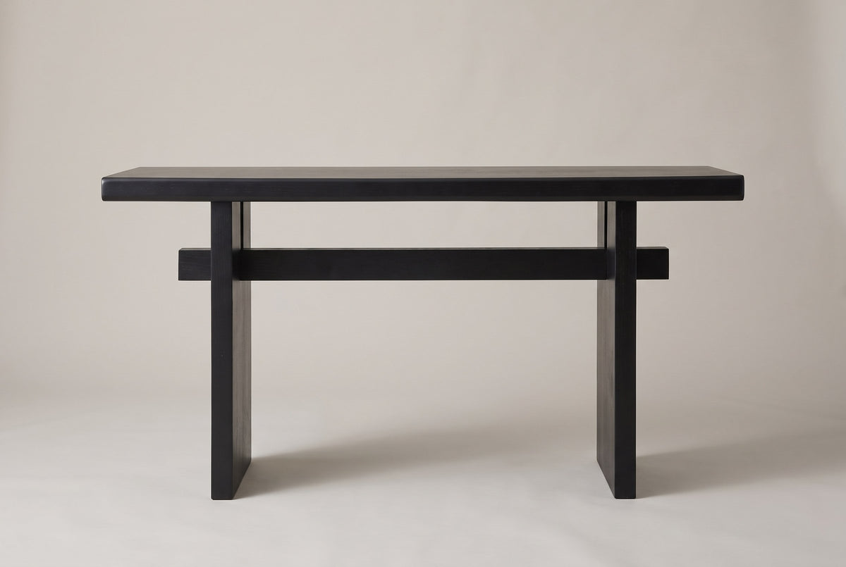 Sanremo console table in black, straight front view: a thick top, two slab legs and one stretcher through both
