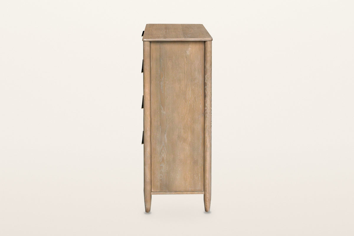 Side view of the Sarnano chest in Sand on a warm white studio backdrop: a flat oak side panel between two round posts that en