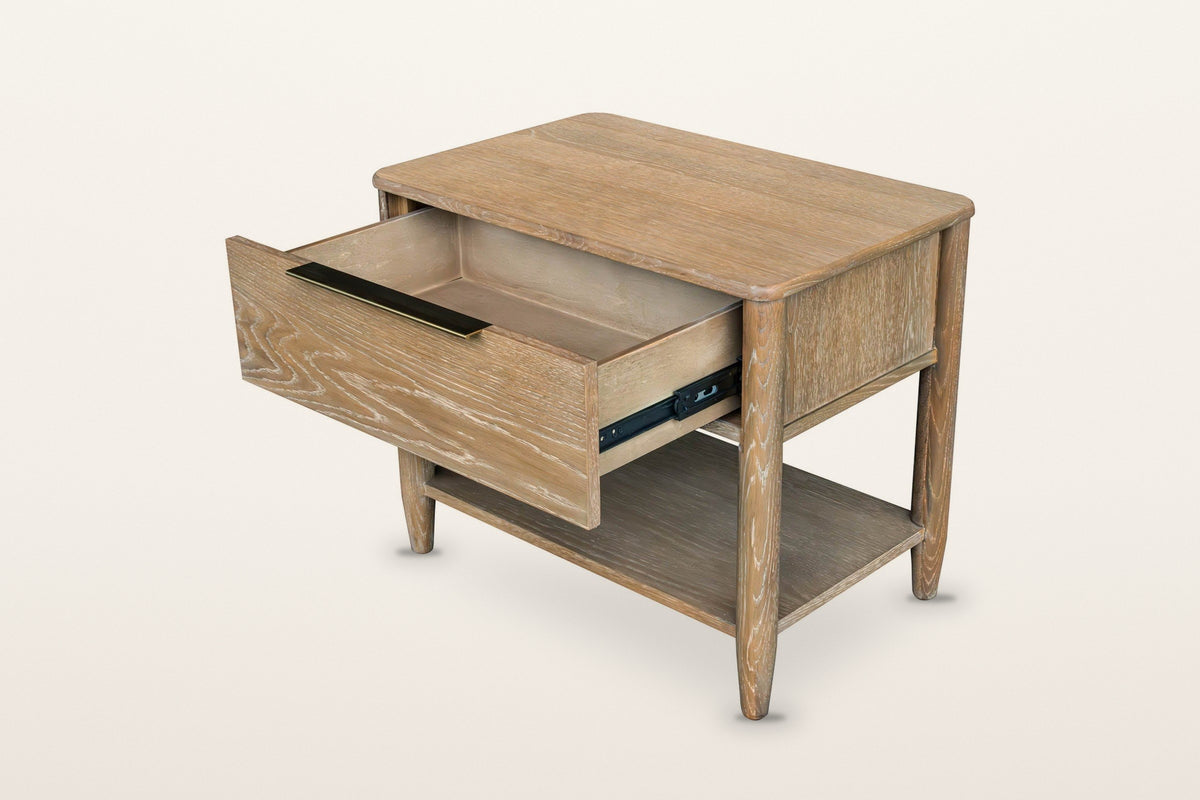 Sarnano nightstand in Sand with the drawer pulled out, three-quarter view on a warm white studio backdrop