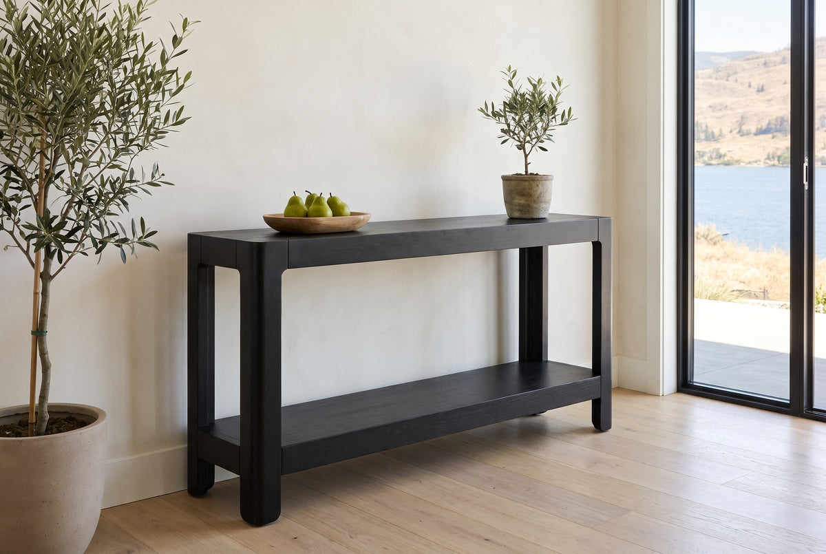 Sarnico console table in the bright entry of a lake house, pears in a wooden bowl and a small olive tree on top