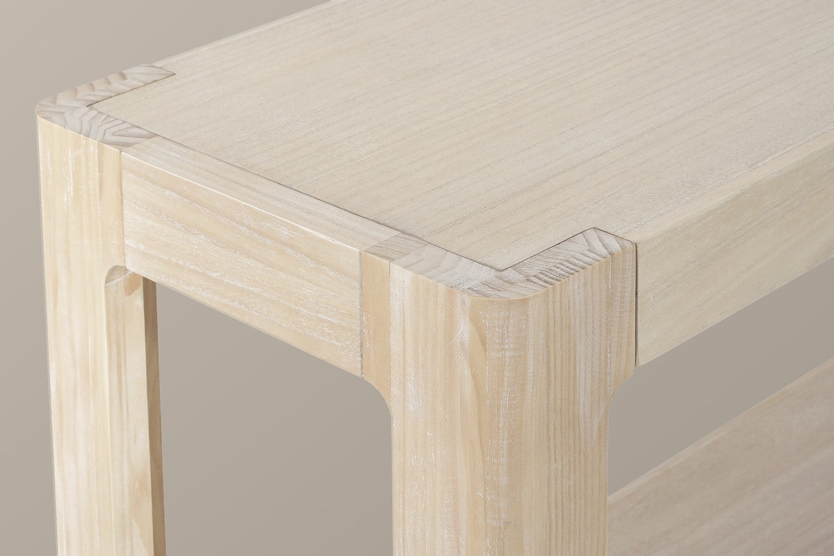 Close-up of a top corner in the natural finish: the framed wood veneer top