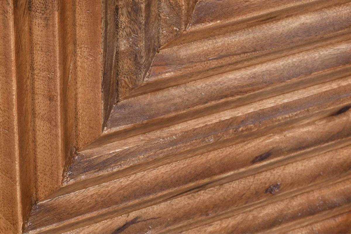 Close-up of the Sarteano door in Pecan mango: rounded carved flutes turning from vertical to horizontal at the diagonal