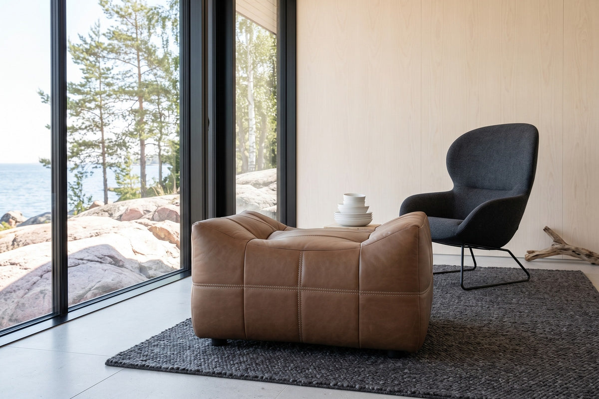 Sassocorvaro ottoman in Antique Sienna seen low from its dipped side in a Helsinki seaside villa