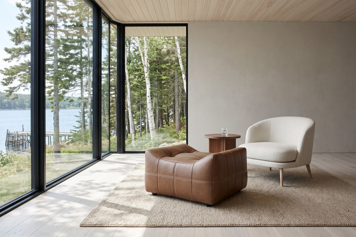 Sassocorvaro leather ottoman in Antique Sienna before an ivory linen lounge chair in a Pictou house