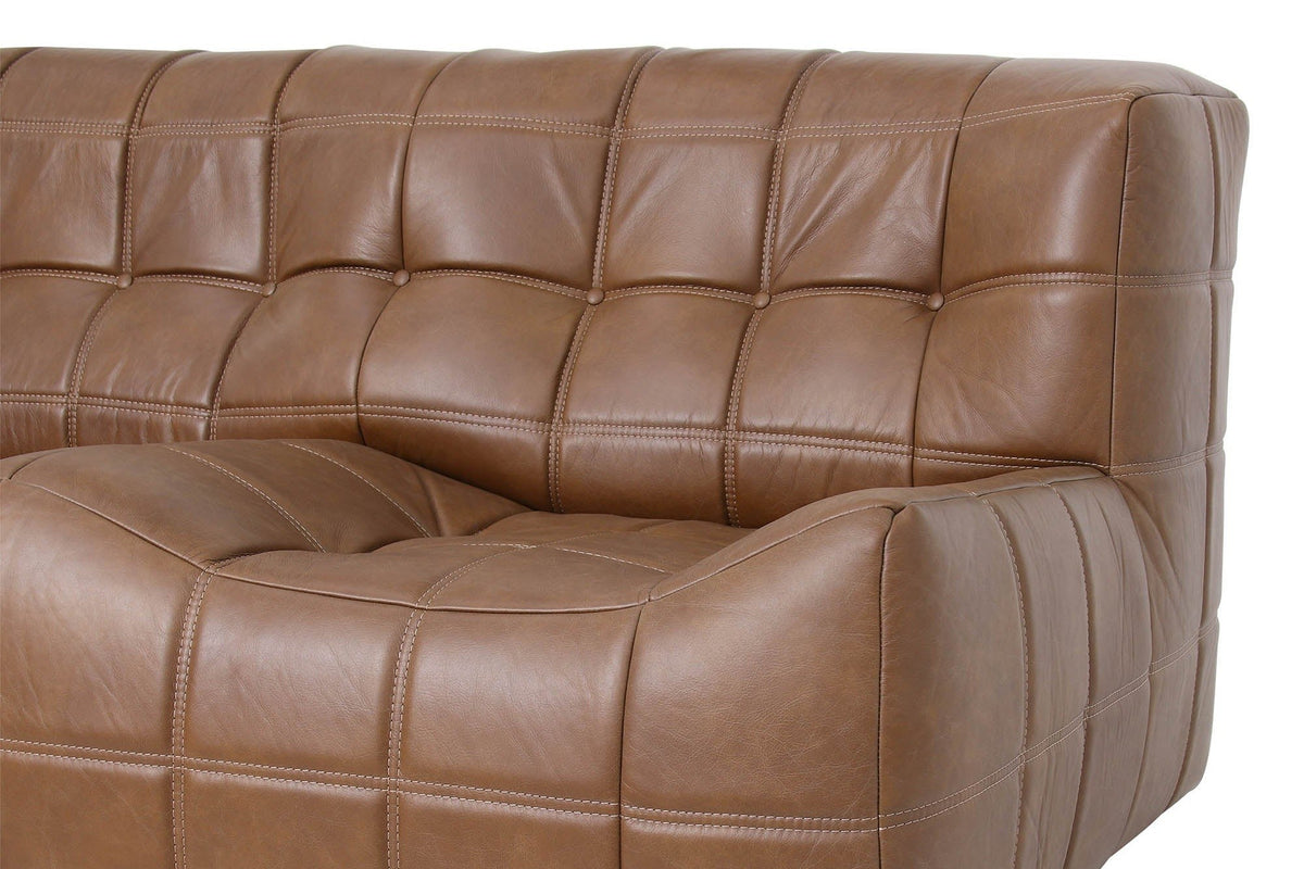 Close-up of the Sassocorvaro corner in Antique Sienna: padded back squares with small round buttons above the seat block's ro