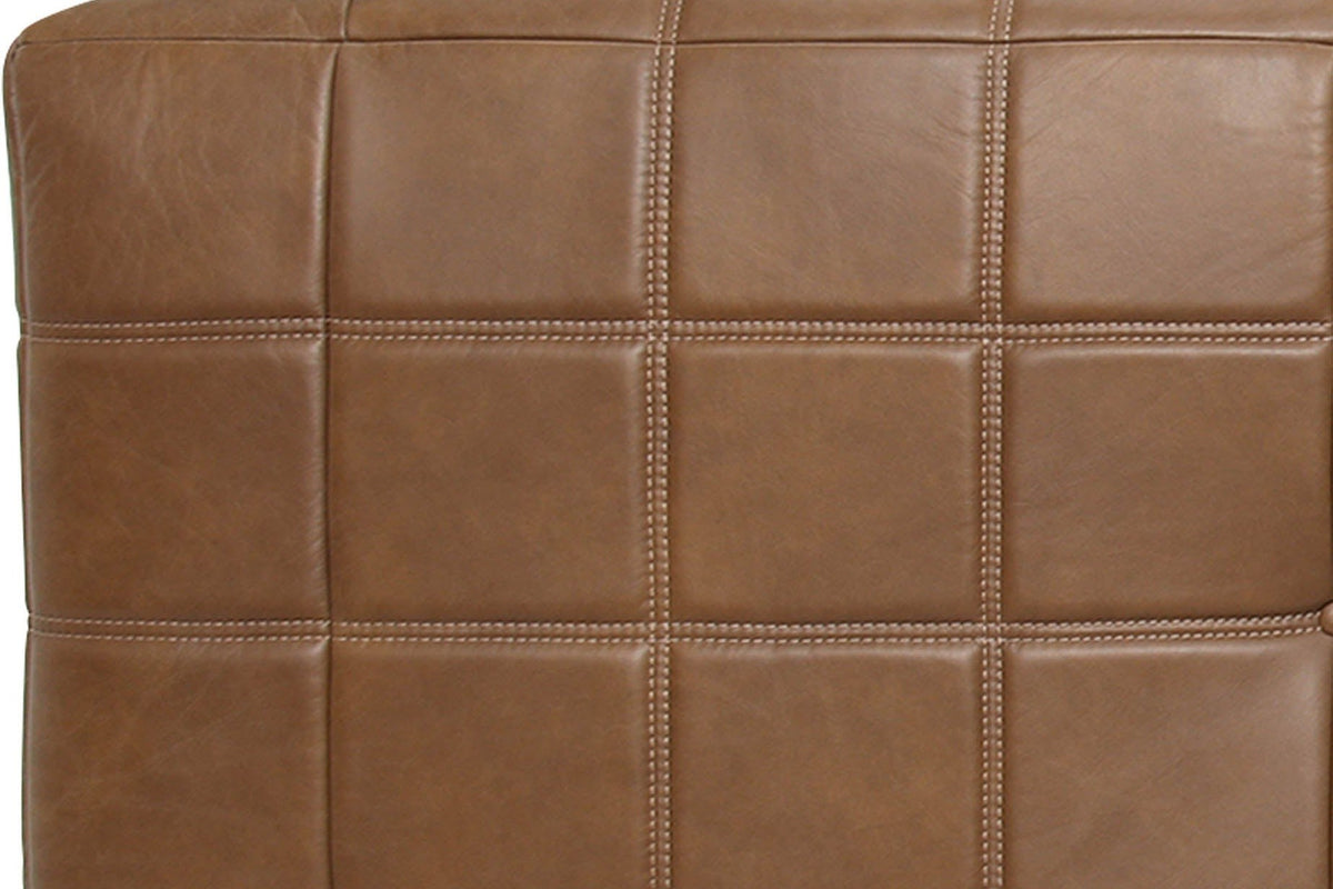 Close-up of the Sassocorvaro leather in Antique Sienna: padded squares with double light-tan top-stitching