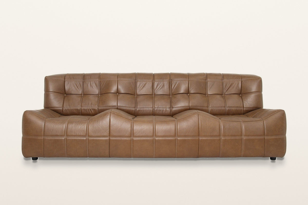 Sassocorvaro sofa in Antique Sienna, straight front view on a warm white studio backdrop: the seat rises in two soft humps