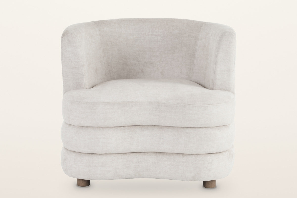 Sauze accent chair in beige, straight front view: the low tub back, the three stacked rolls and two of the round feet