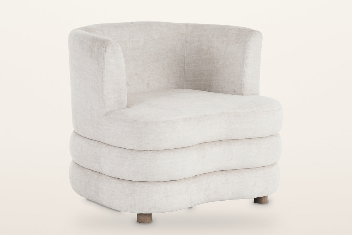 Sauze stacked-roll velvet accent chair in beige, three-quarter view on a warm white studio backdrop