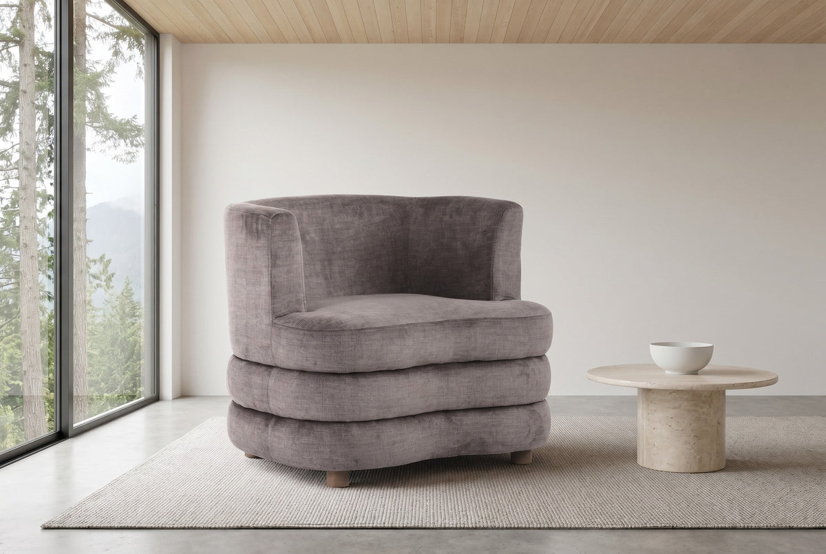 Sauze accent chair in dark taupe velvet in a west-coast living room in North Vancouver, cedars and misty mountains through the tall window