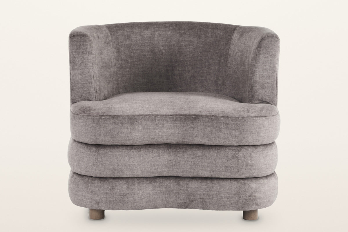 Sauze accent chair in dark taupe, straight front view: the low tub back, the three stacked rolls and two of the round feet