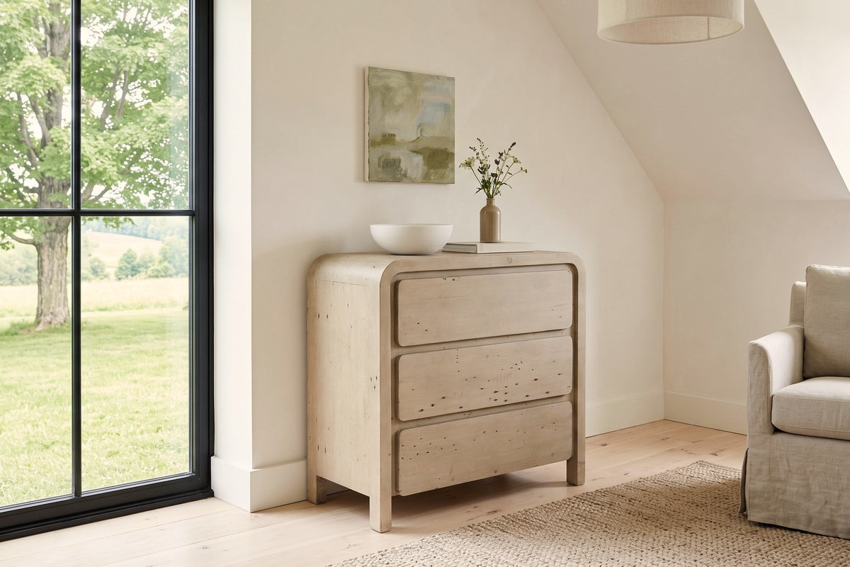Scheggino chest in a Stanstead stone house in the Eastern Townships, with warm white limewash, a sloped ceiling