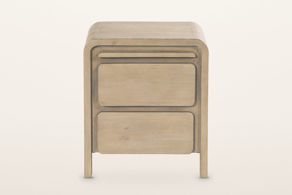 Scheggino nightstand, front view on a warm white studio backdrop: the rounded front frame around a slim tray and two drawers