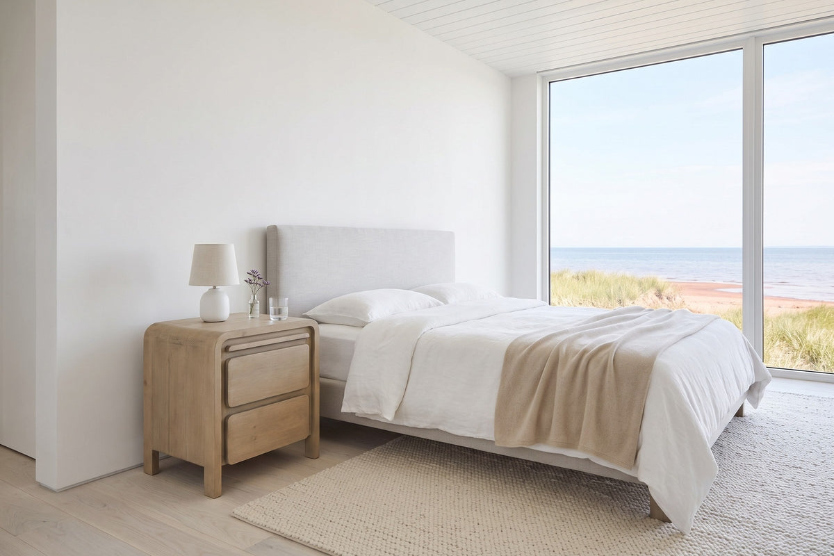 Scheggino nightstand in pale reclaimed pine beside the bed in a Summerside bedroom on Prince Edward Island