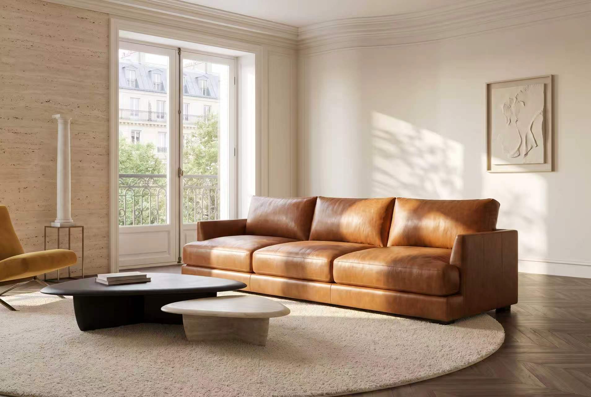 Serena three-seat leather sofa in Cognac in a sunlit room with a balcony door