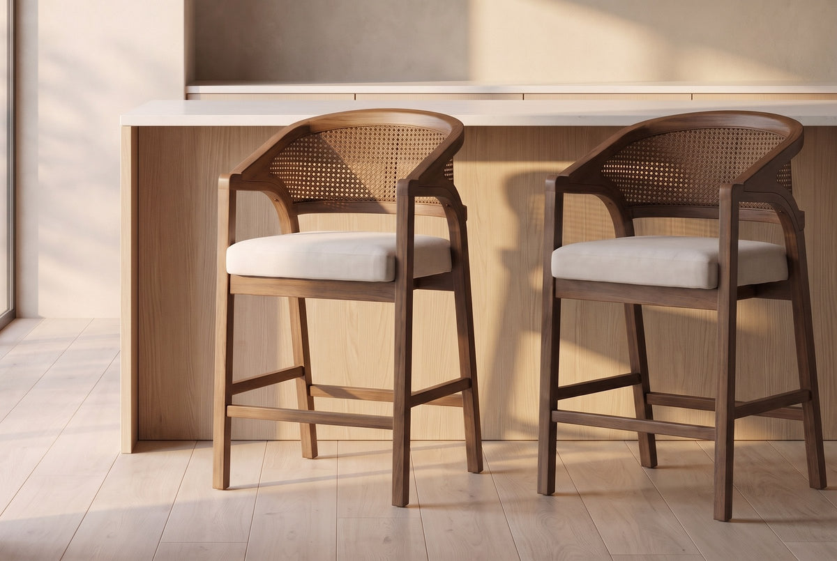Two Sermoneta counter stools in Walnut in front of a pale oak island with a white stone top in a plaster-walled kitchen at go