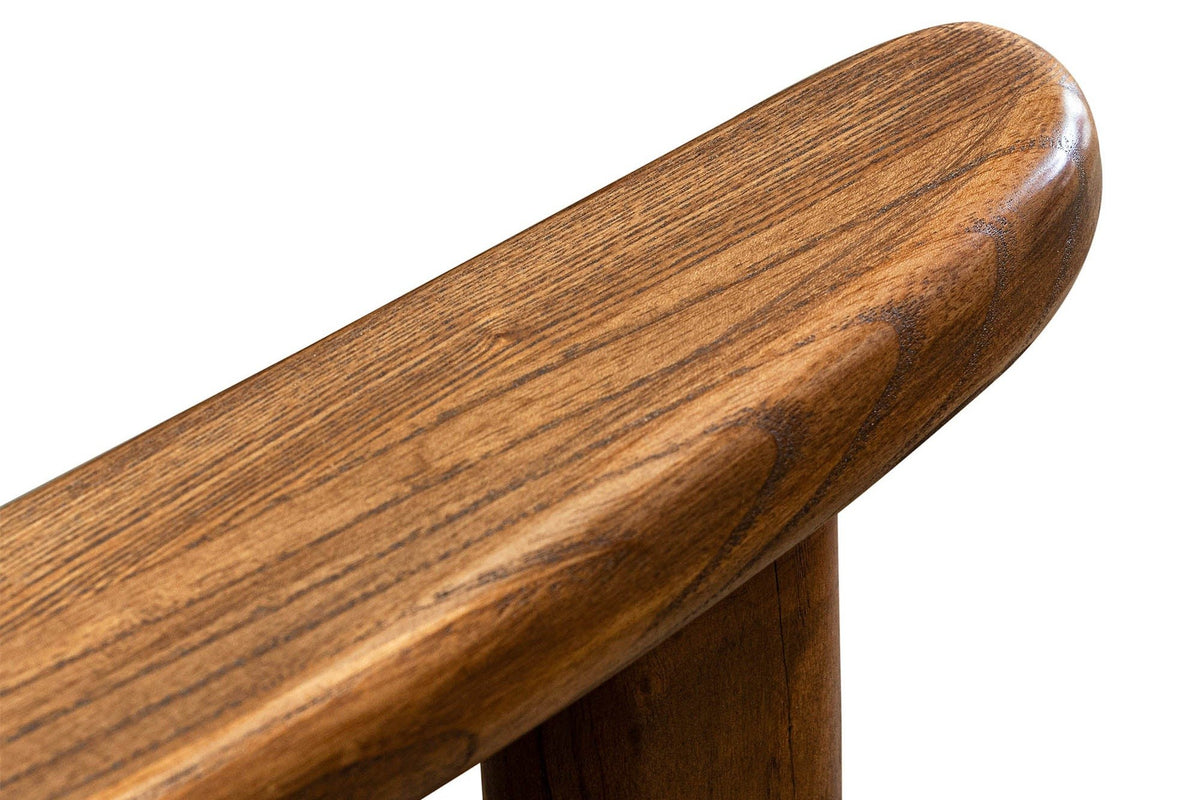 Close-up of a Servigliano arm: the flat ash arm with a rounded end resting on the round front leg