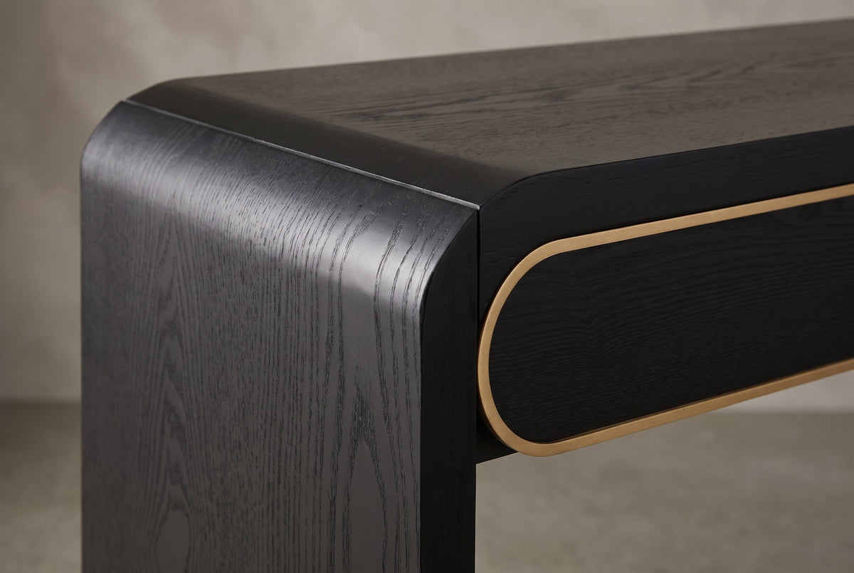 Close-up of the black top turning down through a soft rounded bend into the slab leg