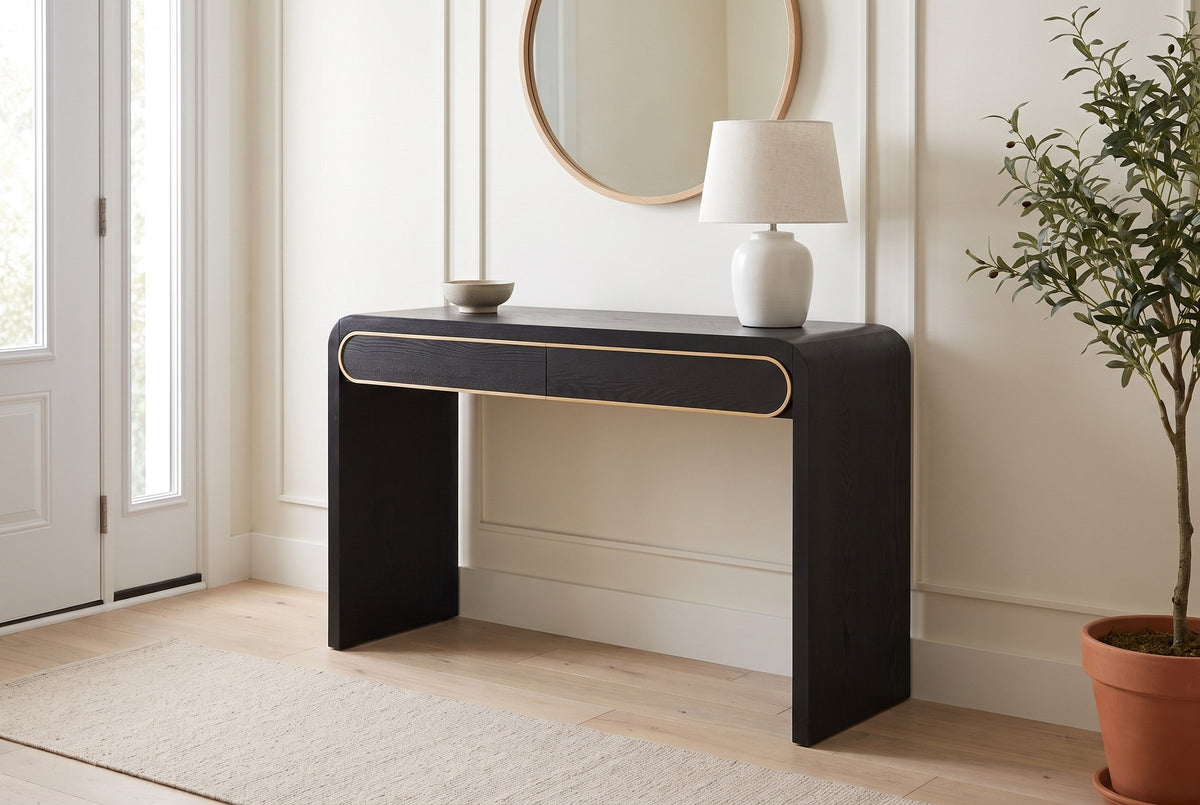 Sestri console table in black in a bright Ottawa front hall, a linen lamp and a stoneware bowl on top
