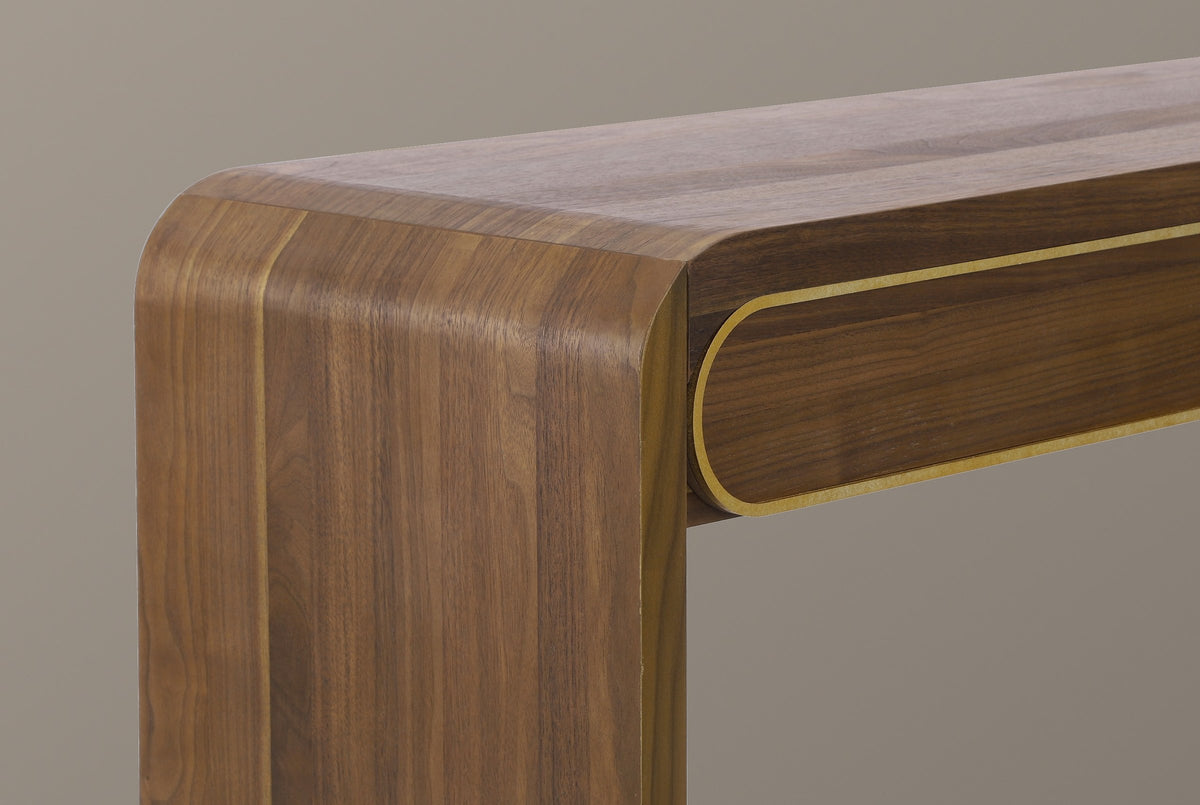 Close-up of the walnut top turning down through a soft rounded bend into the slab leg