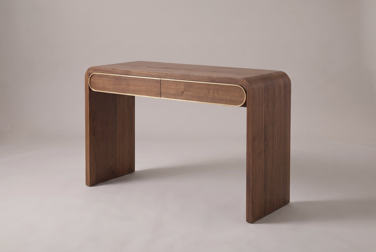 Sestri waterfall console table in walnut, three-quarter view on a warm grey studio backdrop