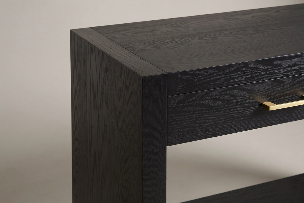 Close-up of the top corner where the black slab side frames the top and the drawer