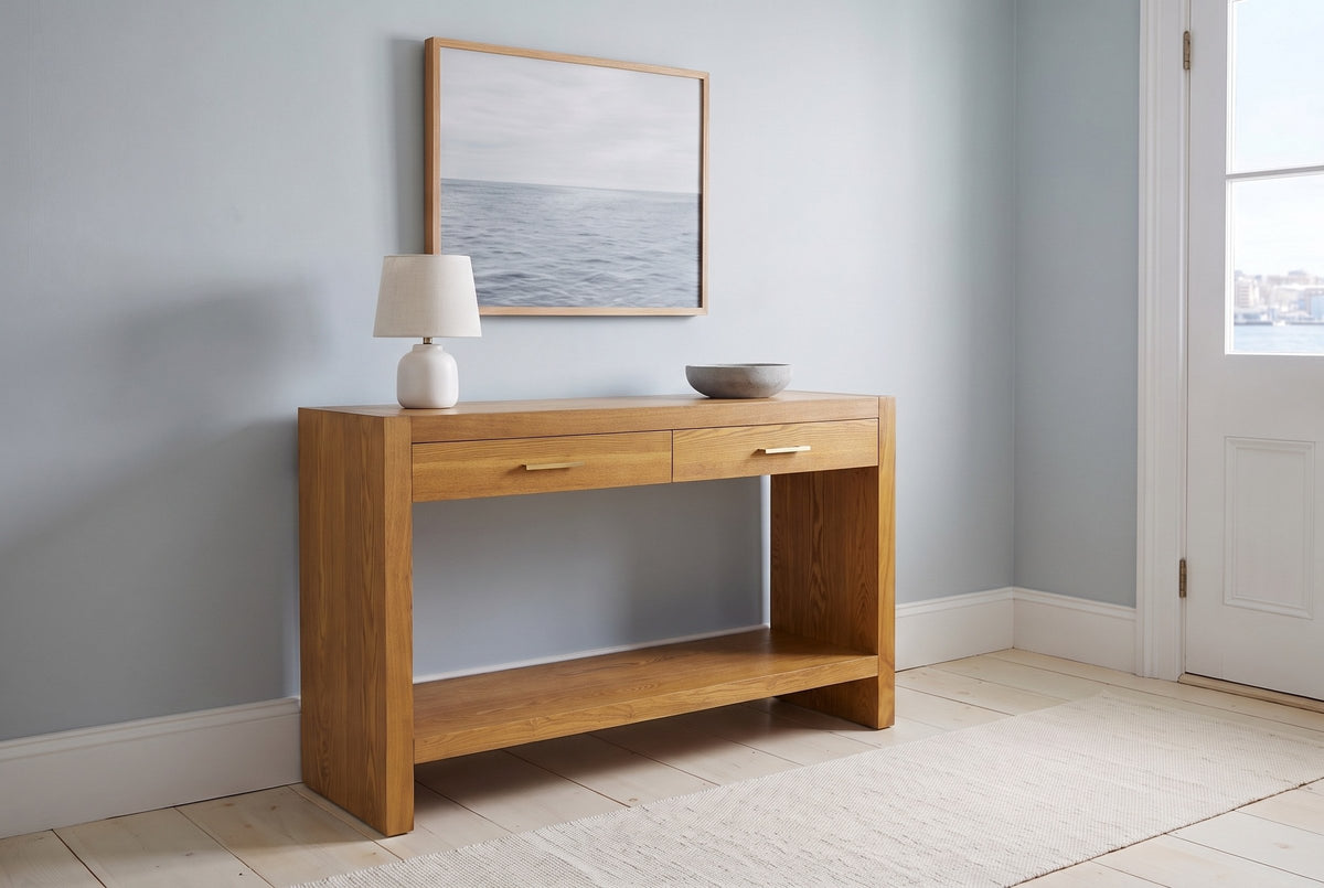 Sibari console table in Natural in a blue-grey Halifax front hall in the morning, a white lamp and a stone bowl on top